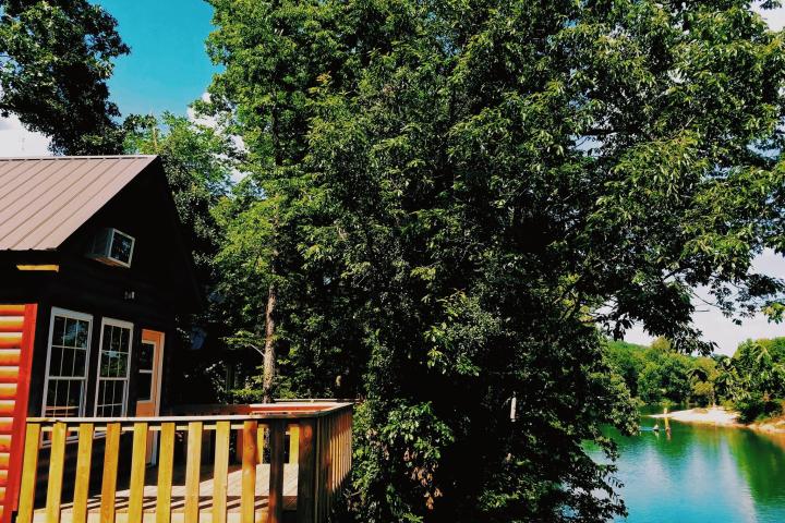 side view of cabin overlooking river