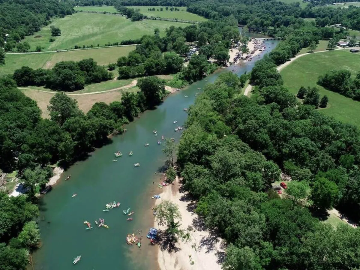 aerial shot of river with kayaks and rafts