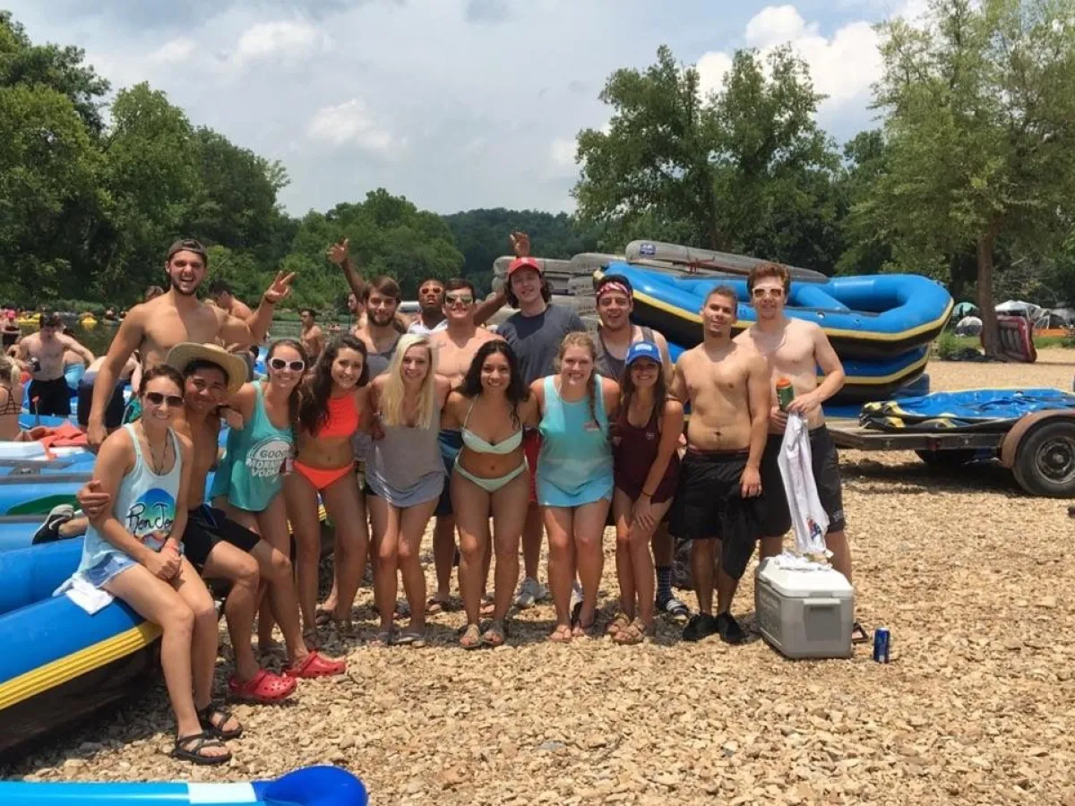 people posing by rafts