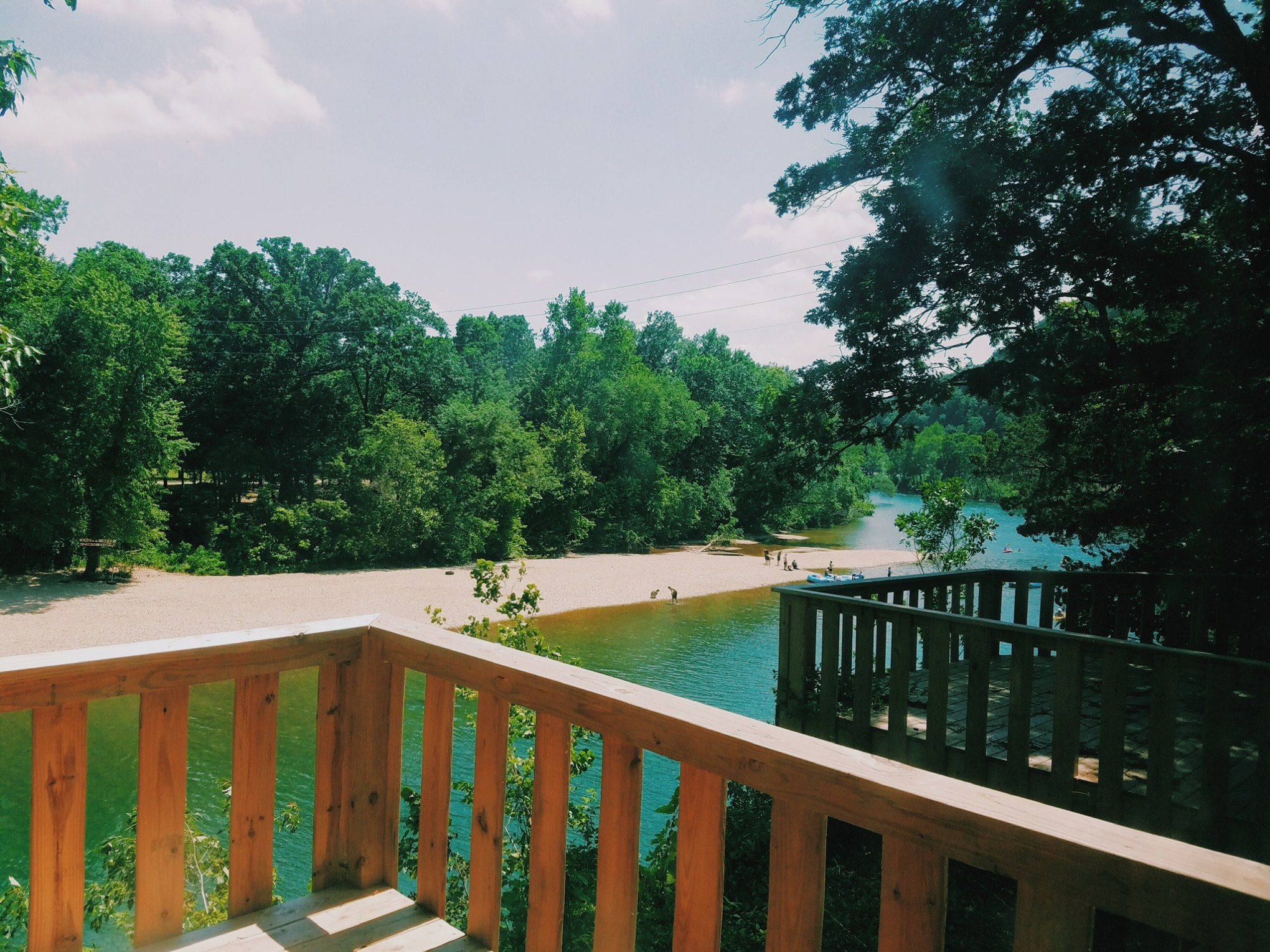 a wooden bench sitting next to a fence