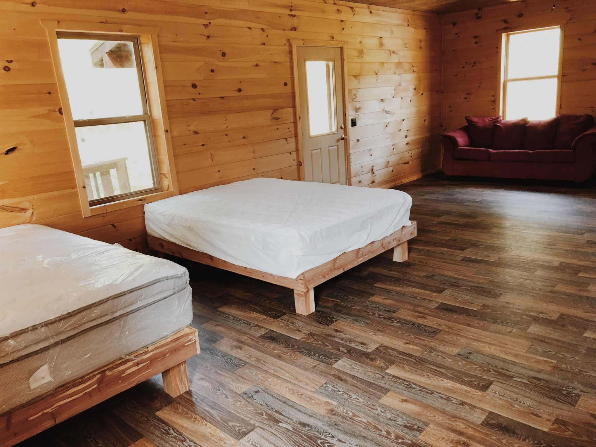 a bedroom with a bed and desk in a room