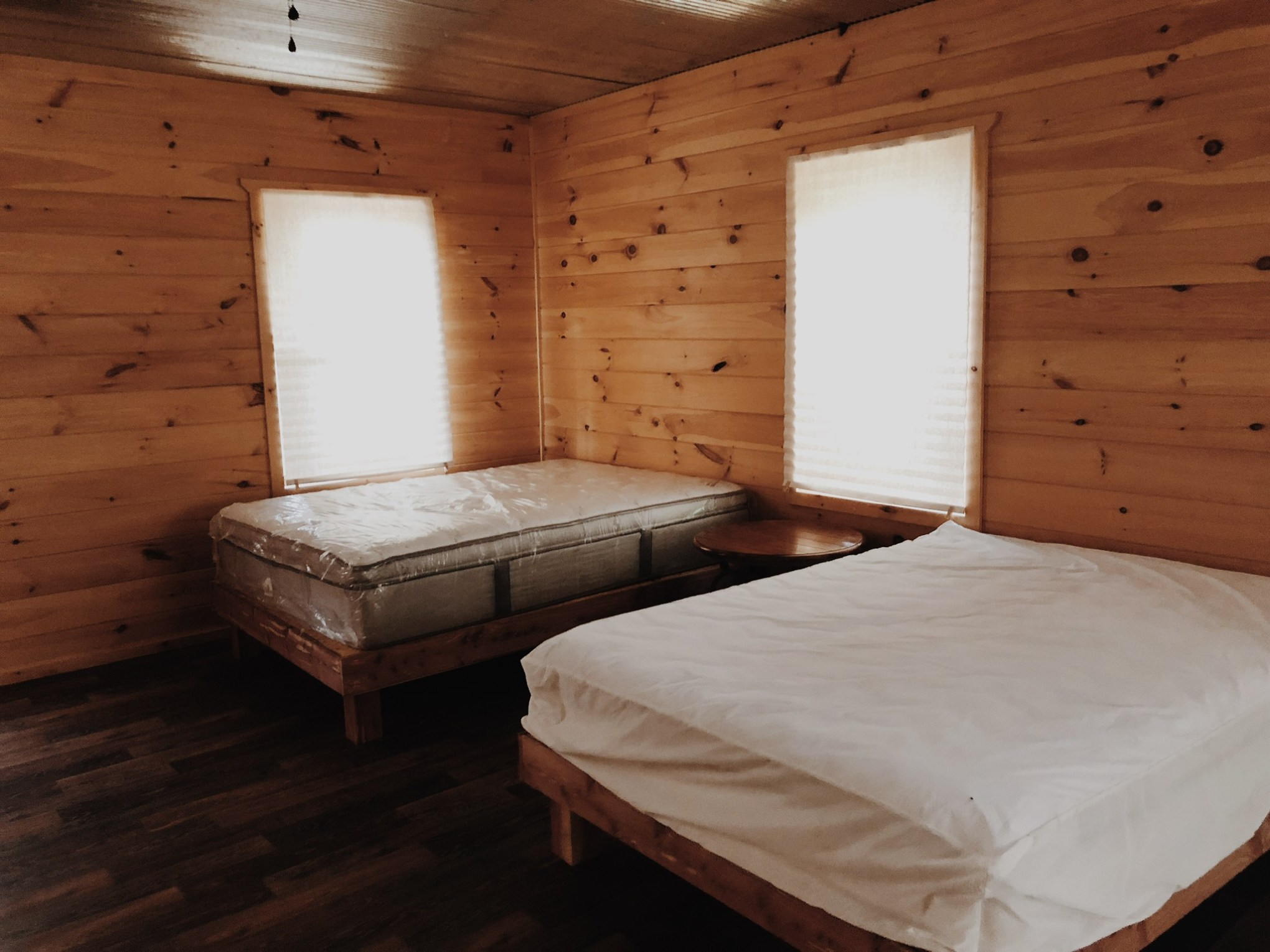 a bedroom with a bed and desk in a room