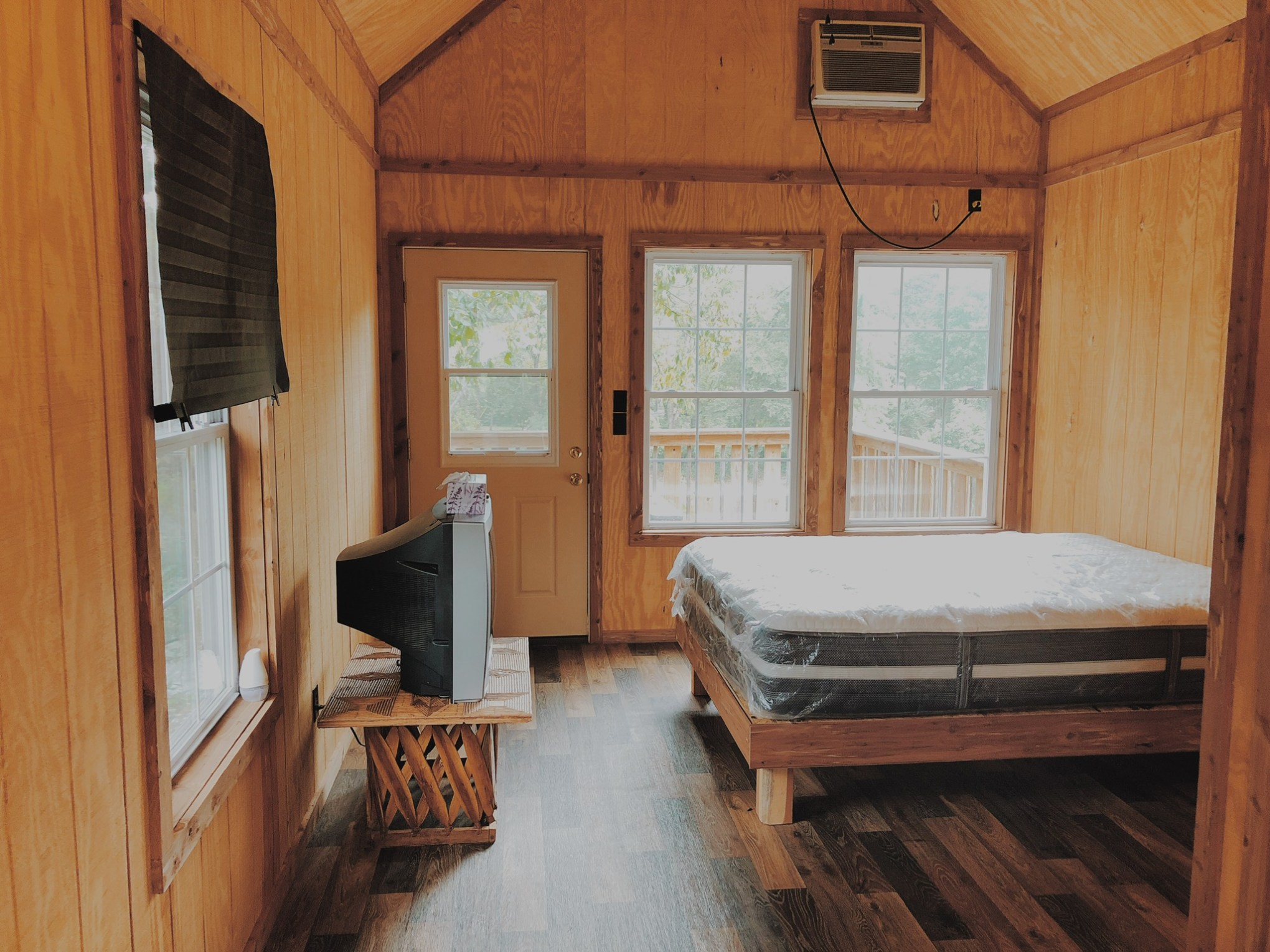 a bedroom with a wooden floor