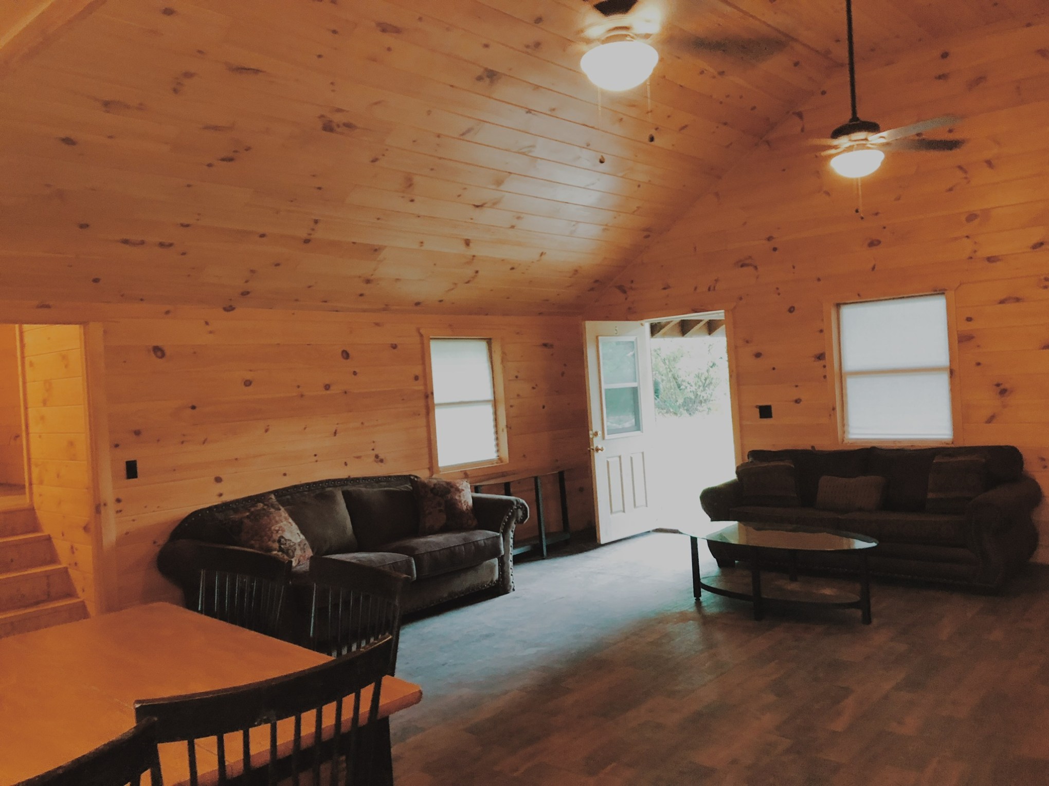 a living room filled with furniture and a wood floor