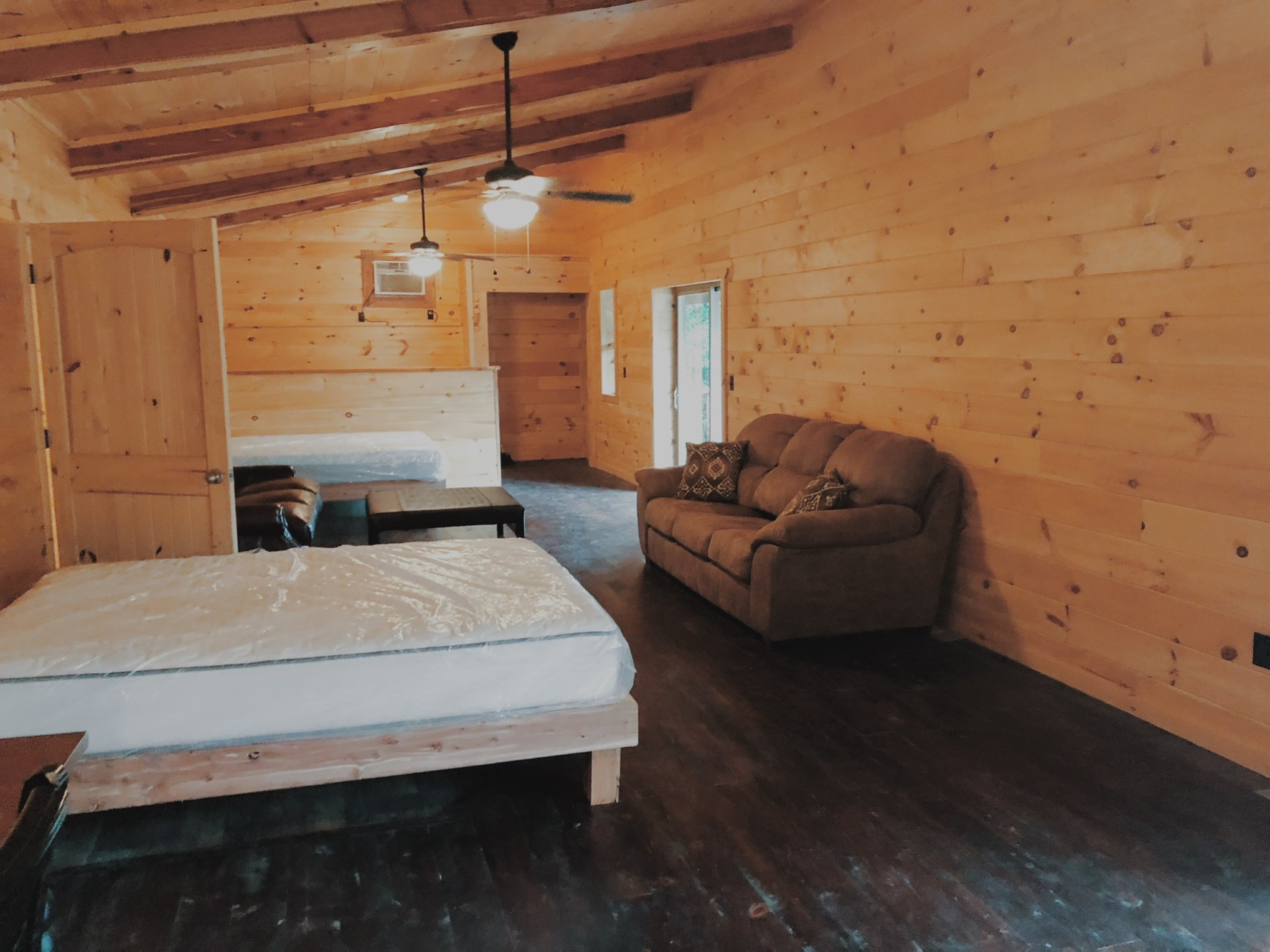 a wooden bed sitting in a room