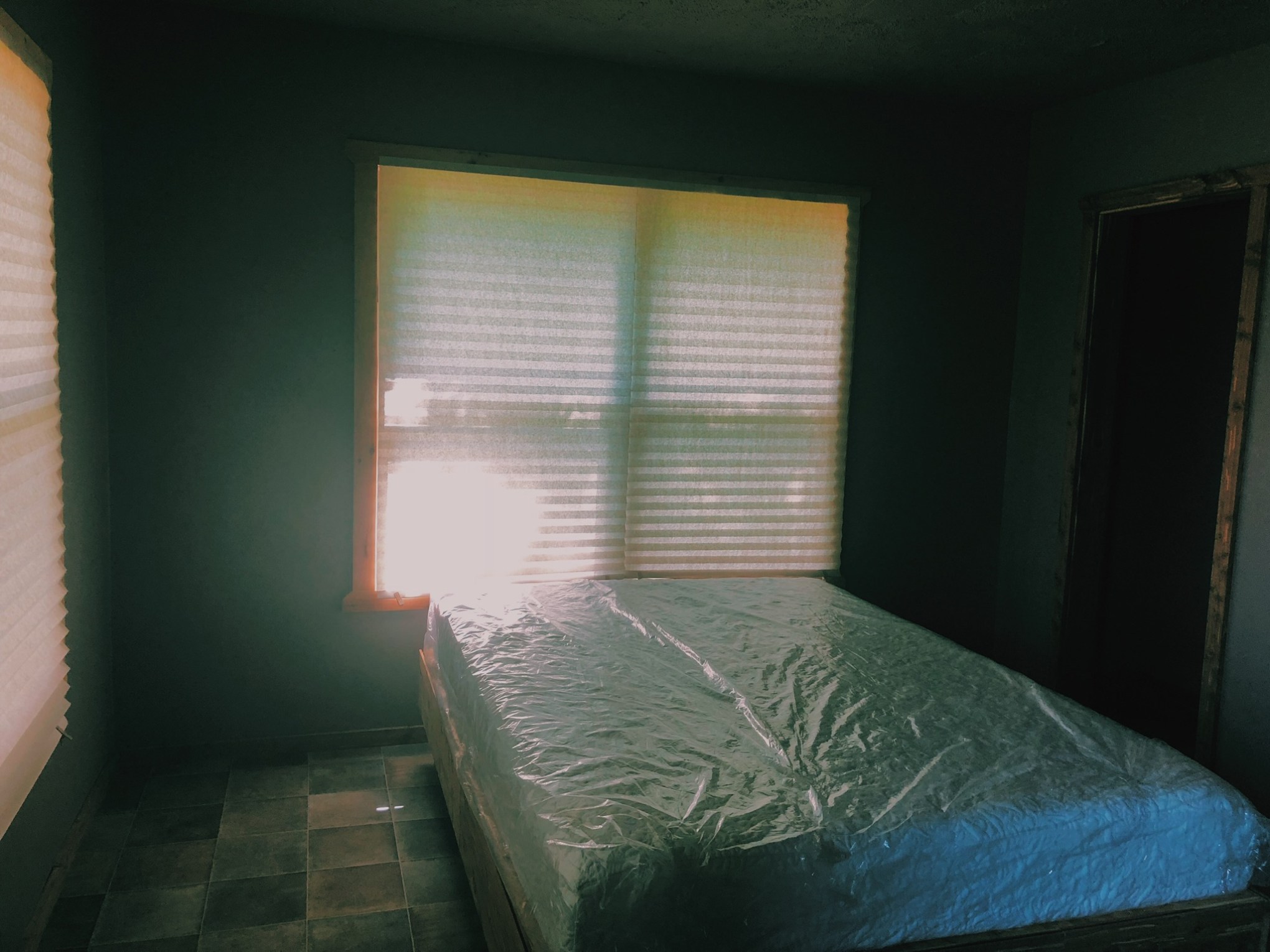 a bedroom with a large window