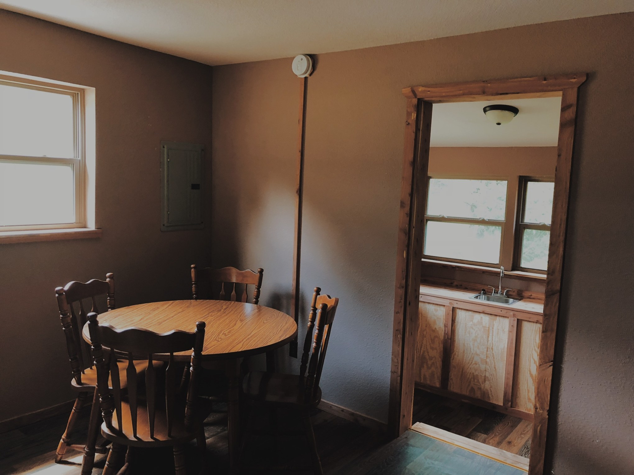 a bedroom with a bed and a chair in a room