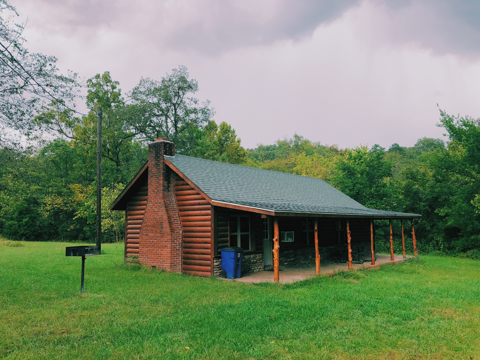 a house in the middle of a lush green field