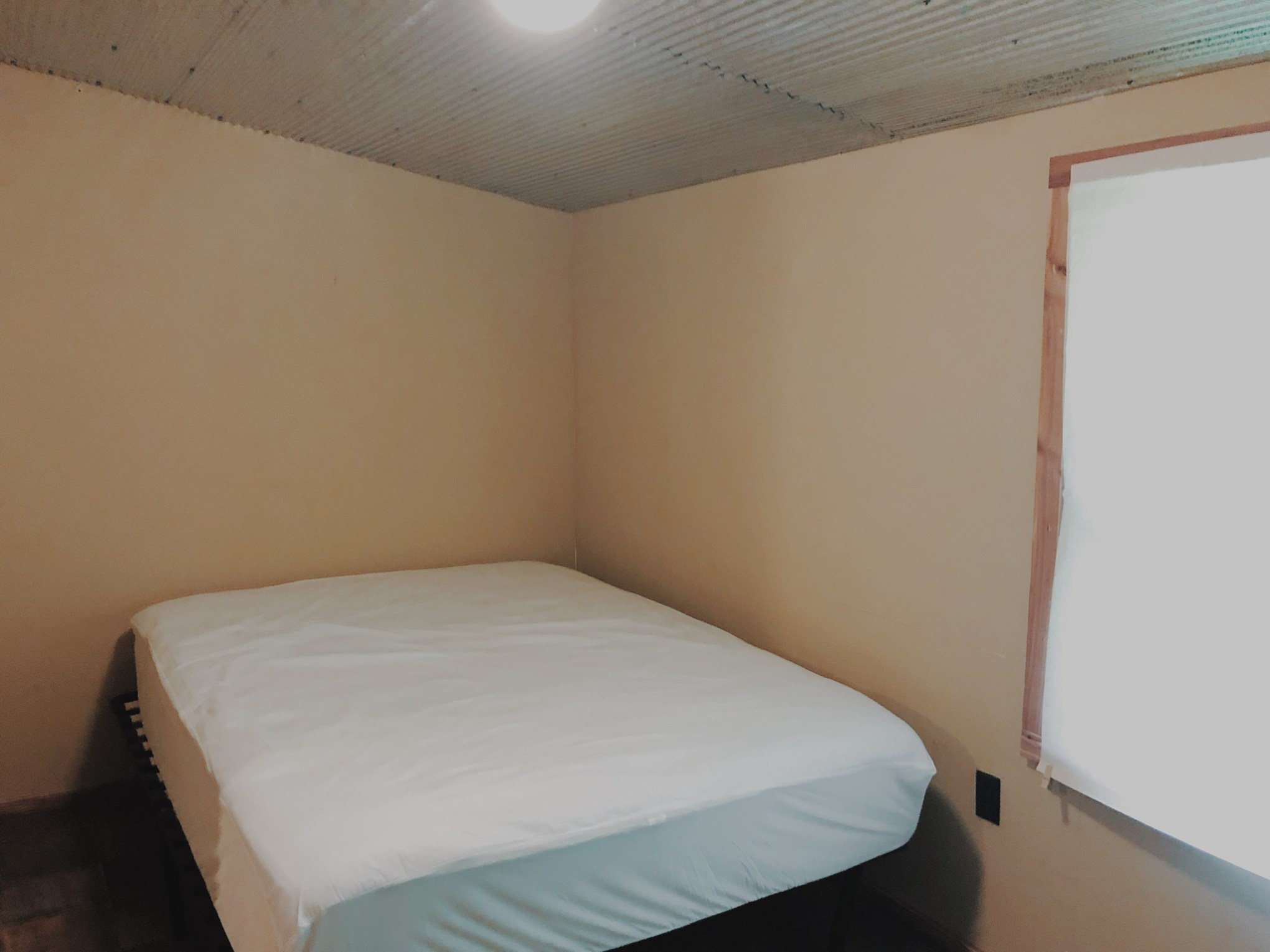 a bedroom with a bed in a room