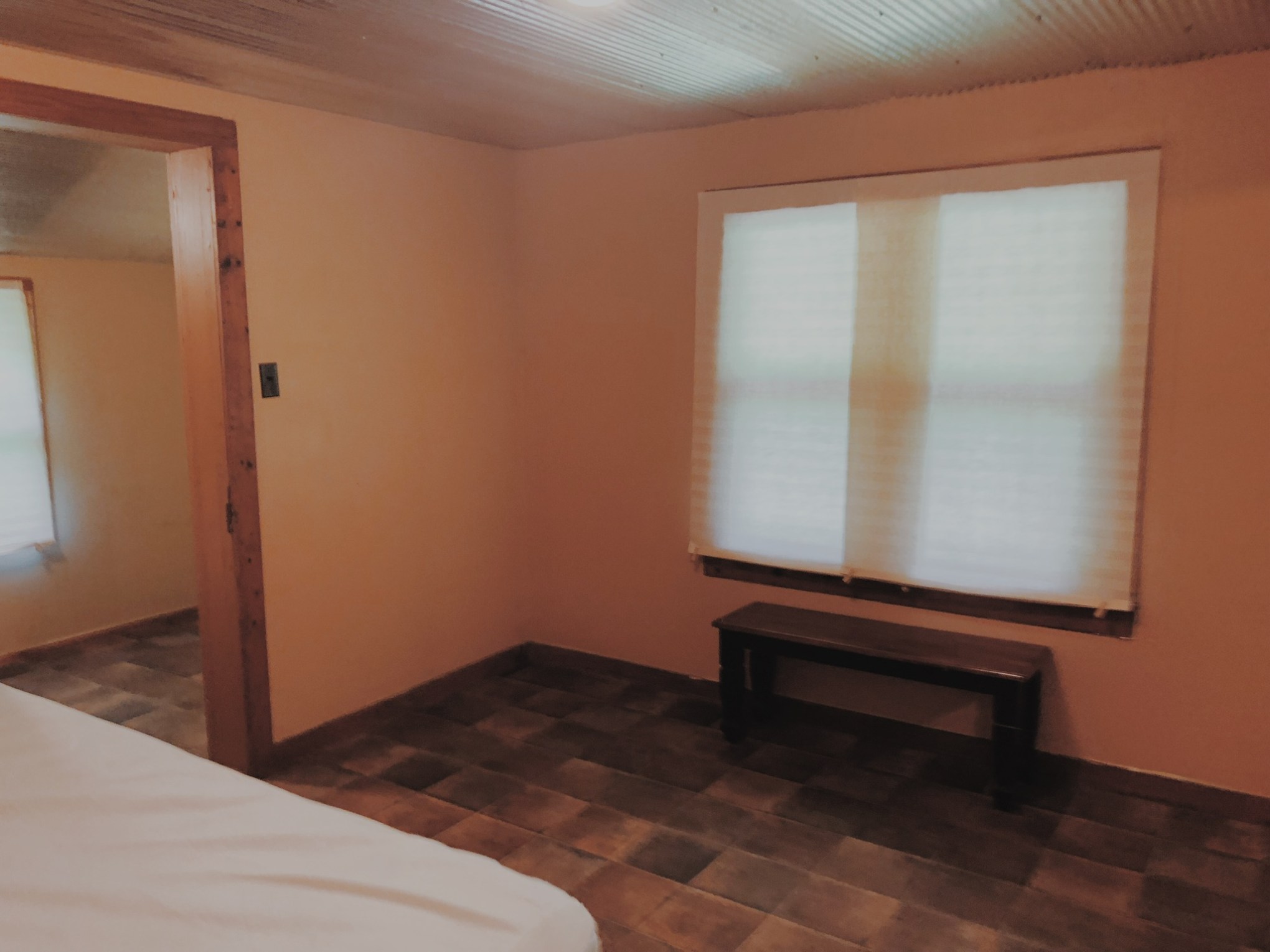 a bedroom with a bed and a mirror