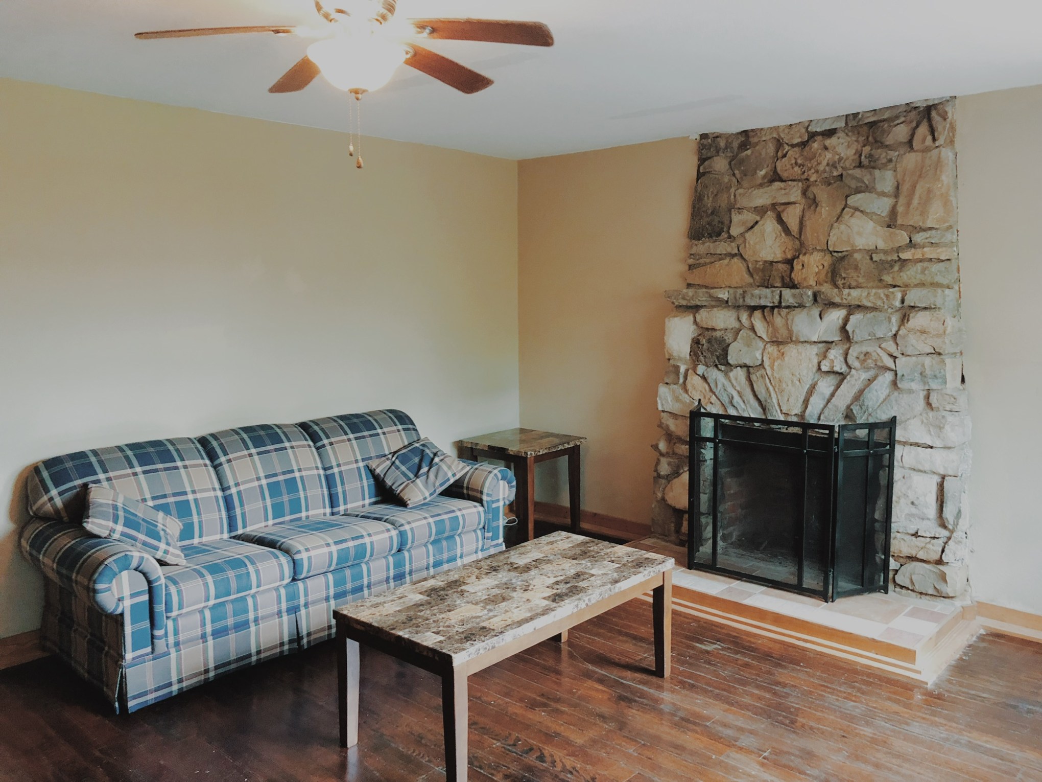 a living room filled with furniture and a fireplace