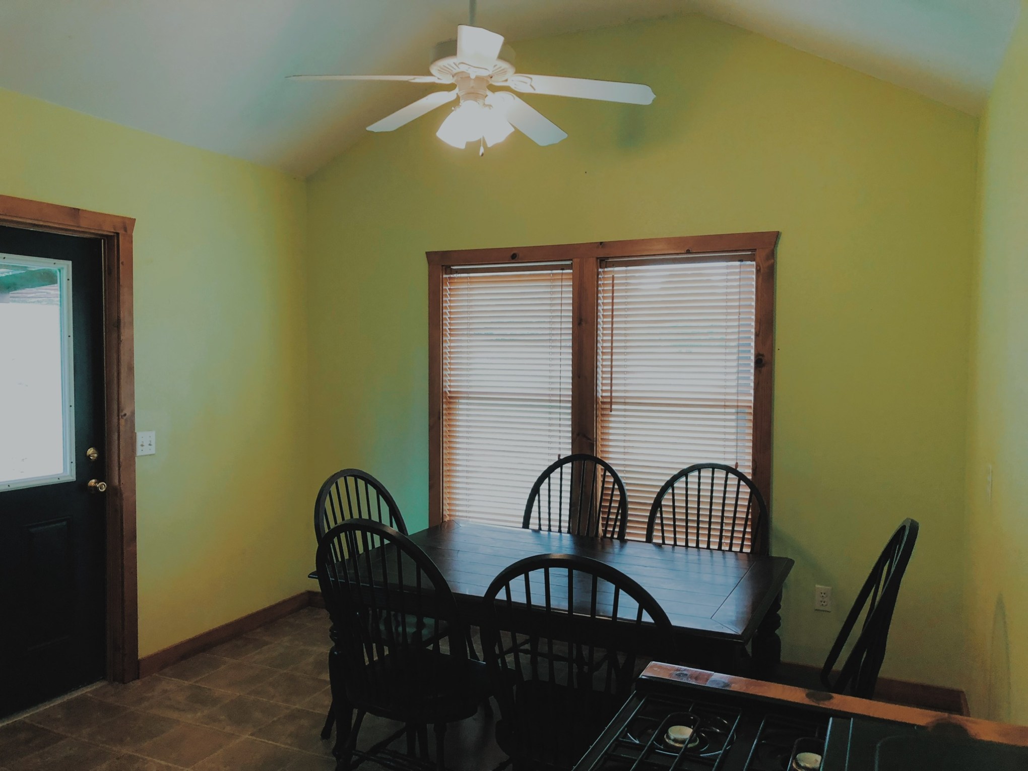 a bedroom with a bed and a chair in a room