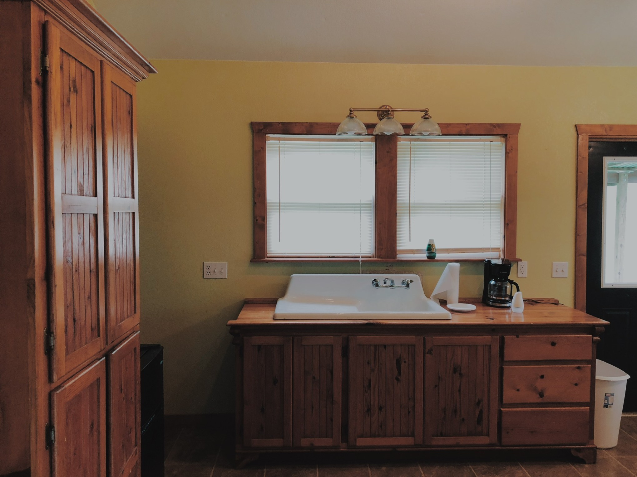 a bedroom with a bed and desk in a room