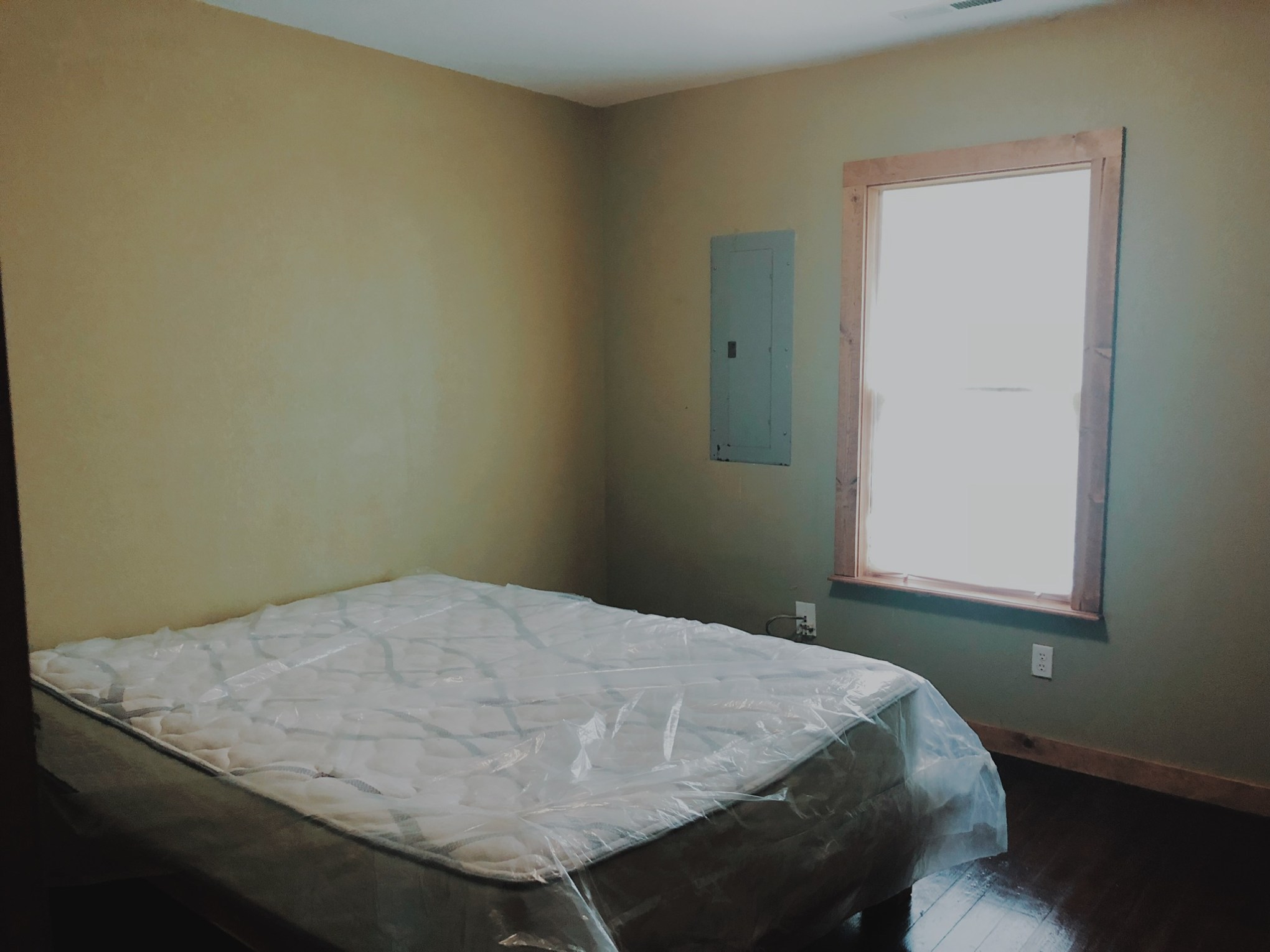 a bedroom with a bed and a mirror