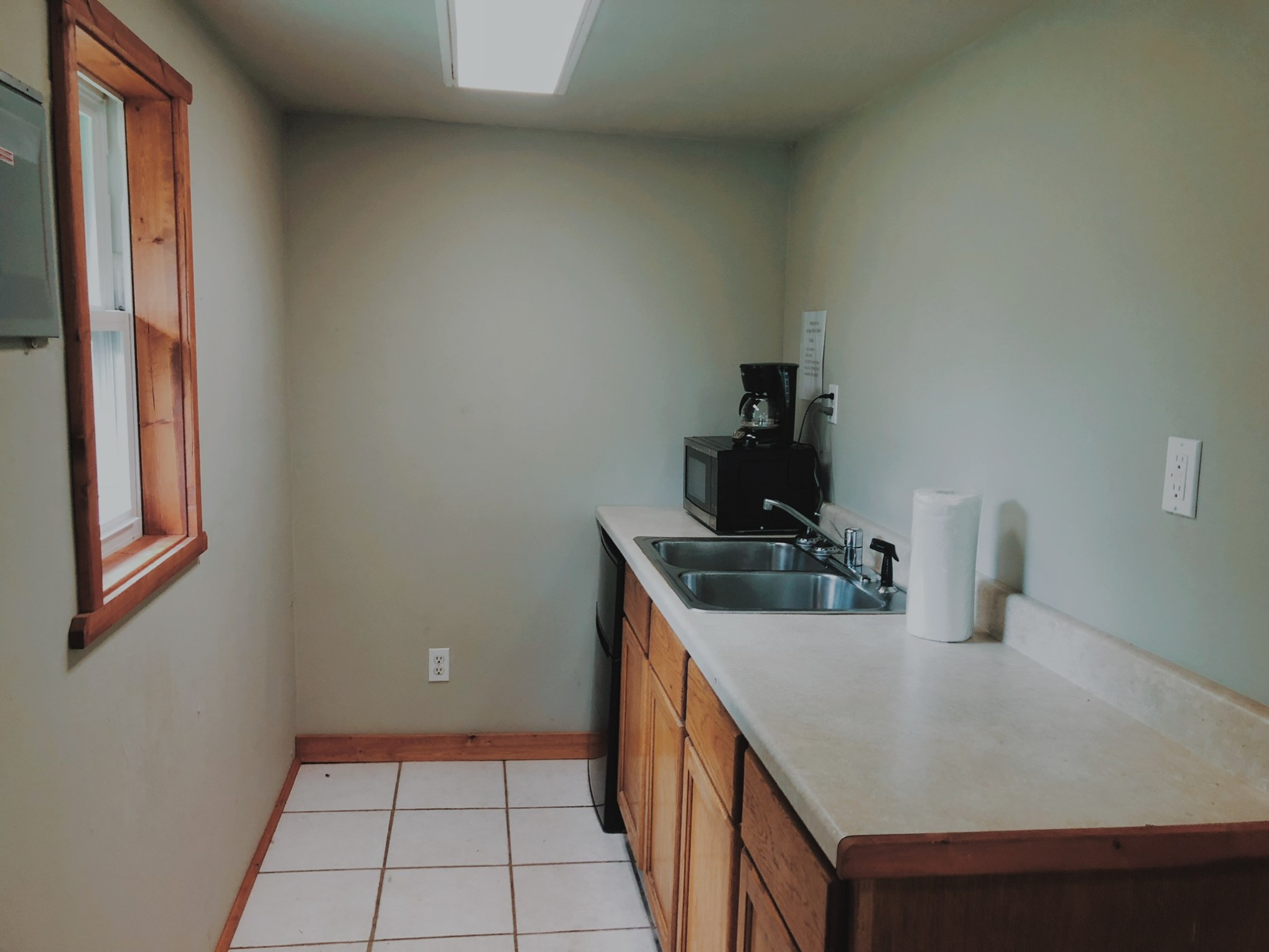 a kitchen with a sink and a mirror