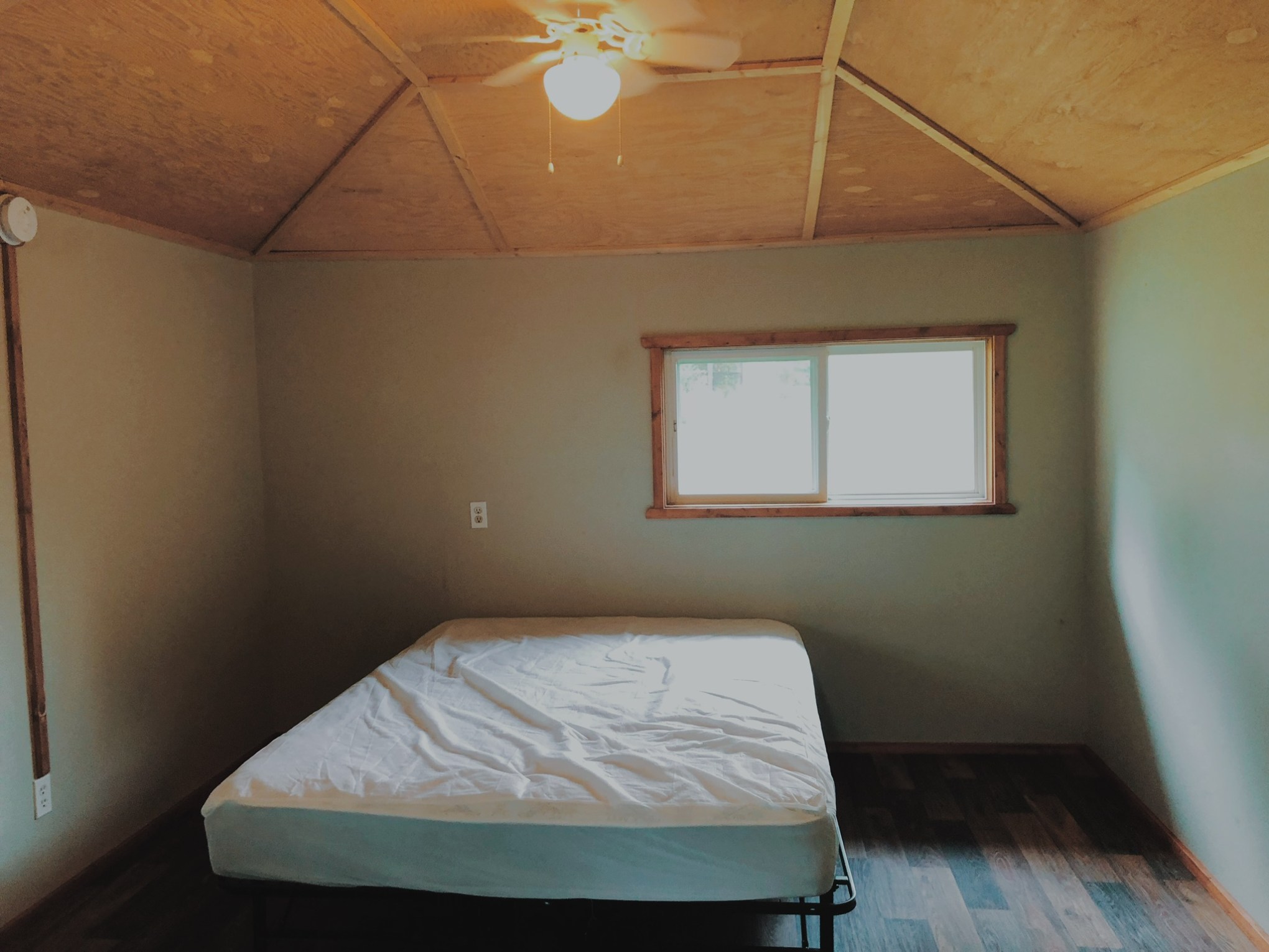 a bedroom with a bed in a room