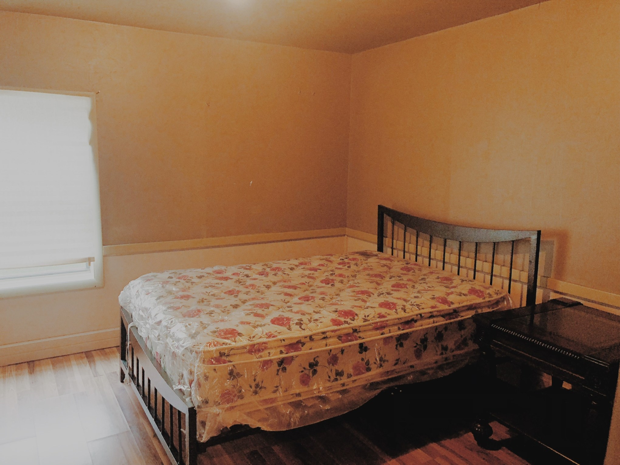 a bedroom with a bed and desk in a small room