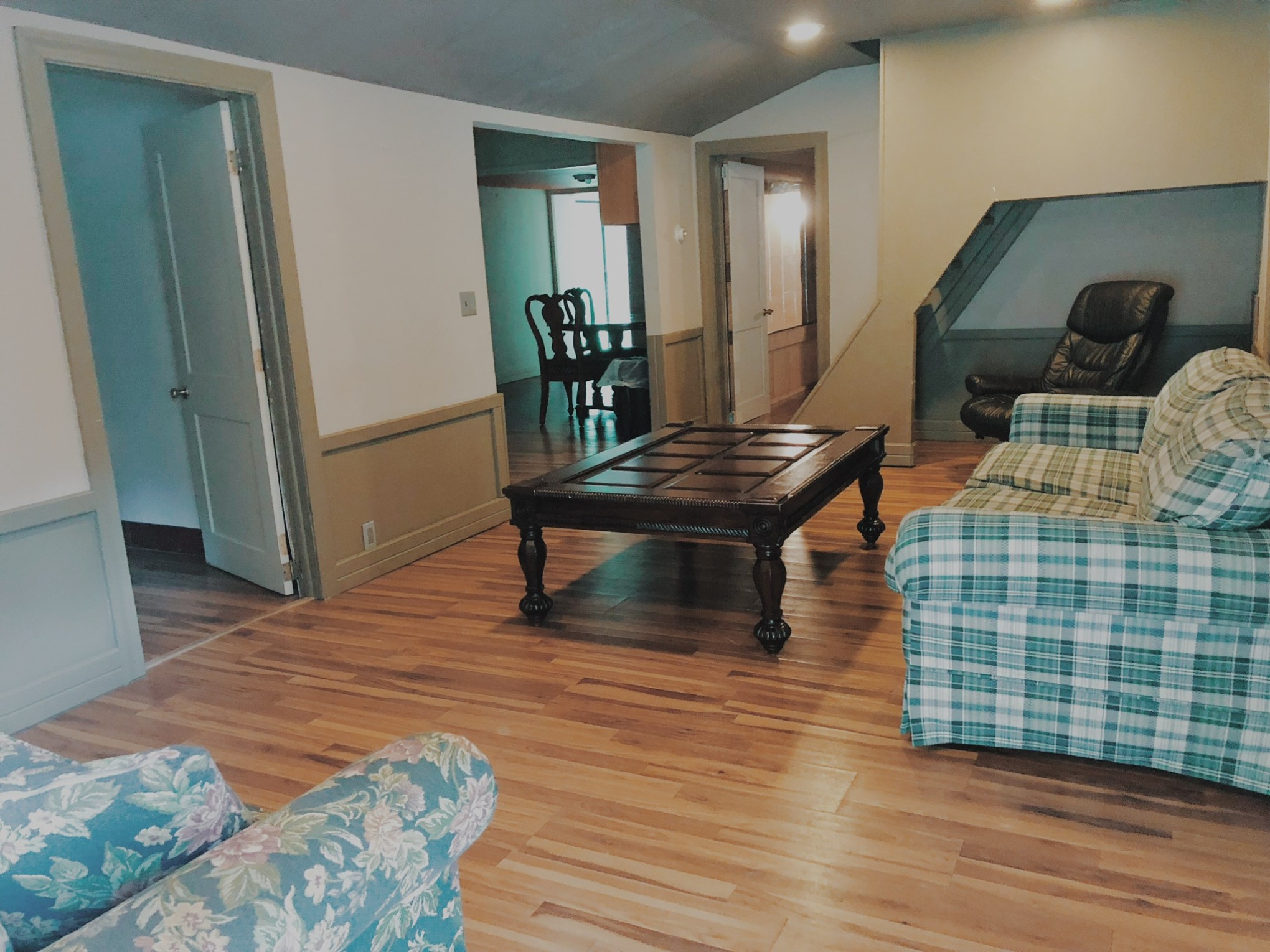 a living room filled with furniture and a wood floor