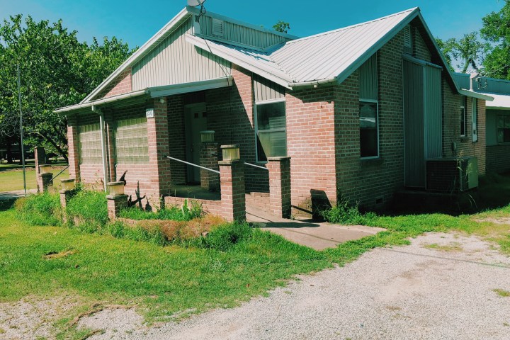a house with trees in the front yard