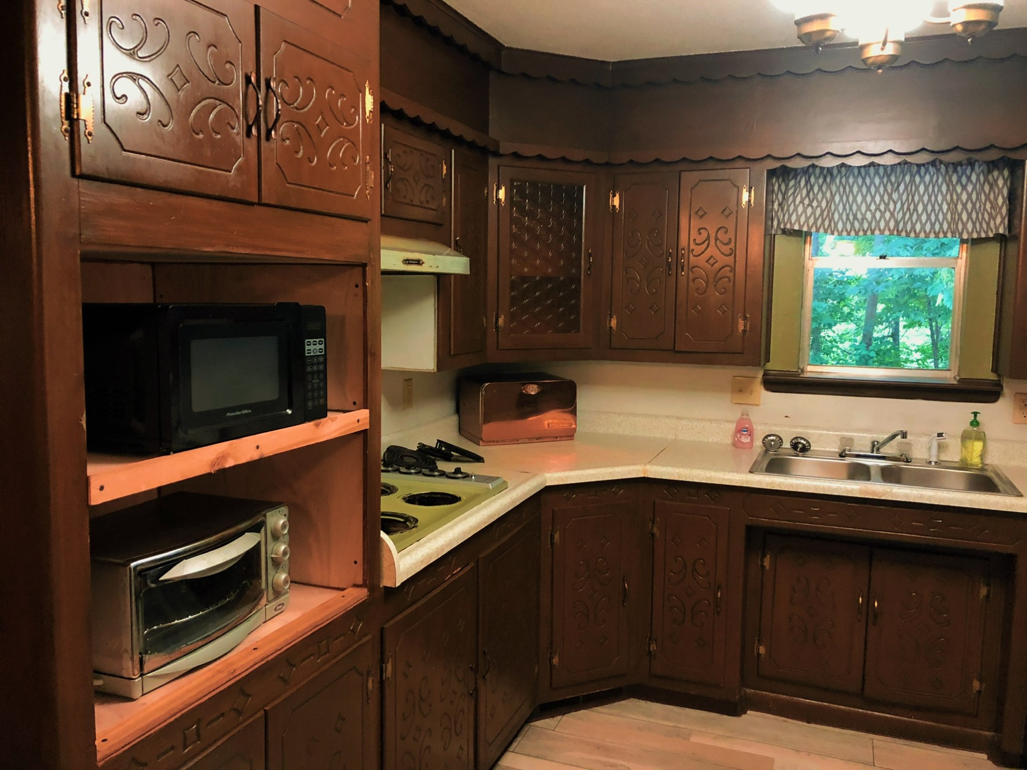a stove top oven sitting inside of a kitchen