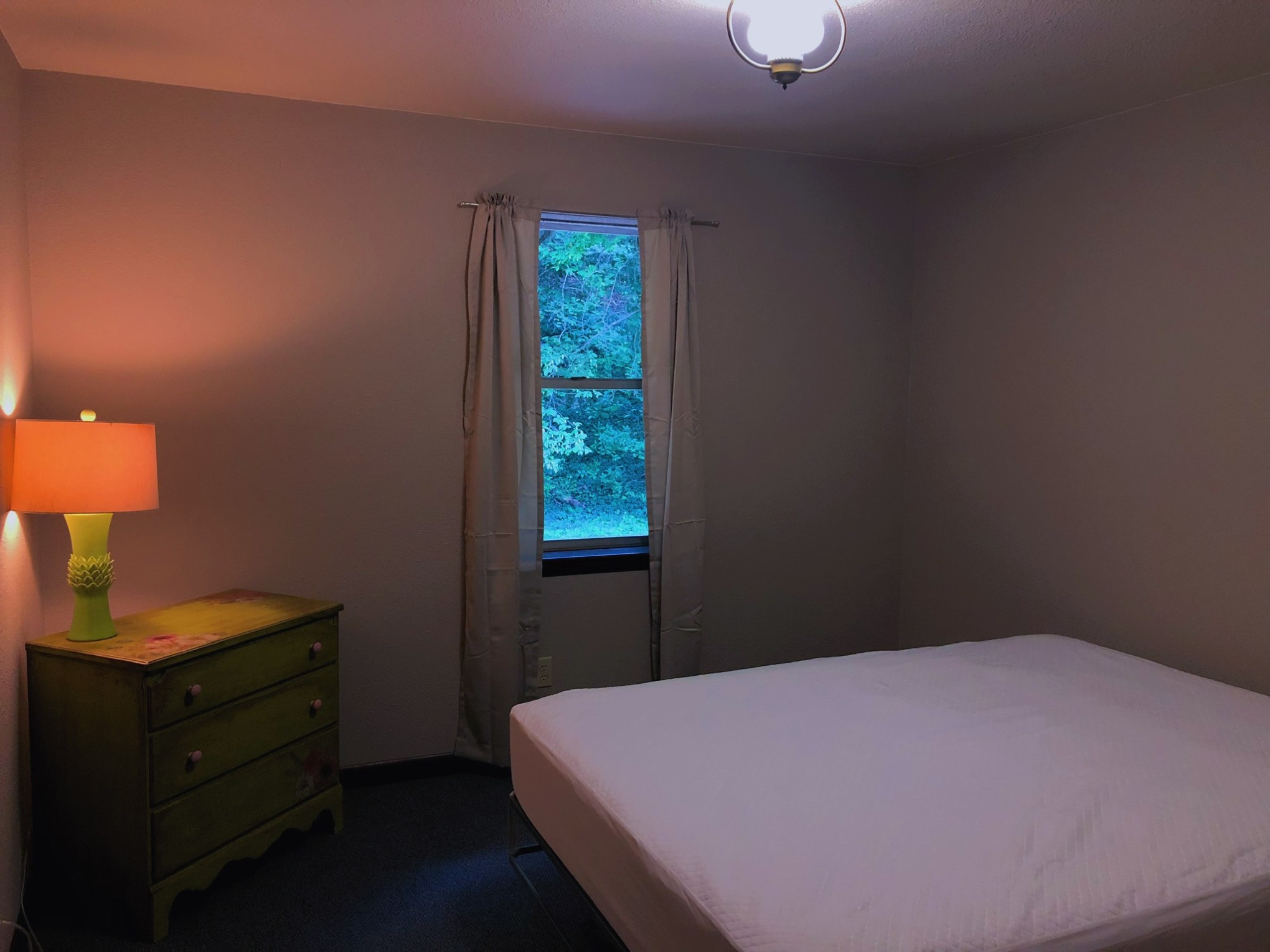 a bedroom with a bed in a room