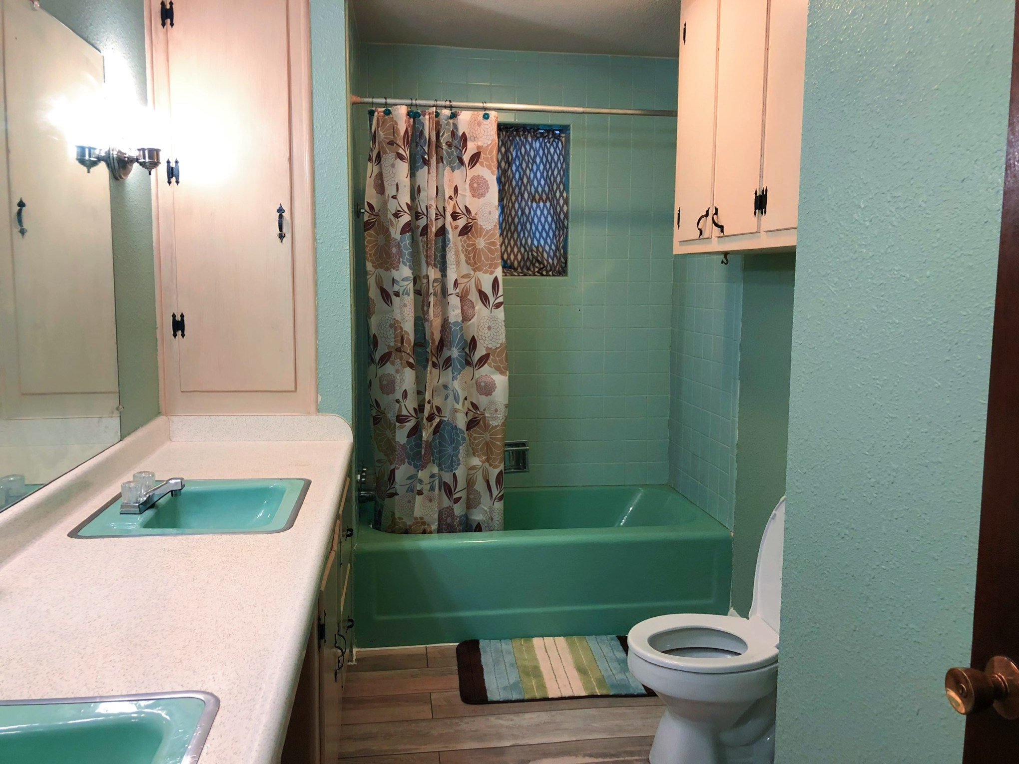 a white sink sitting under a window