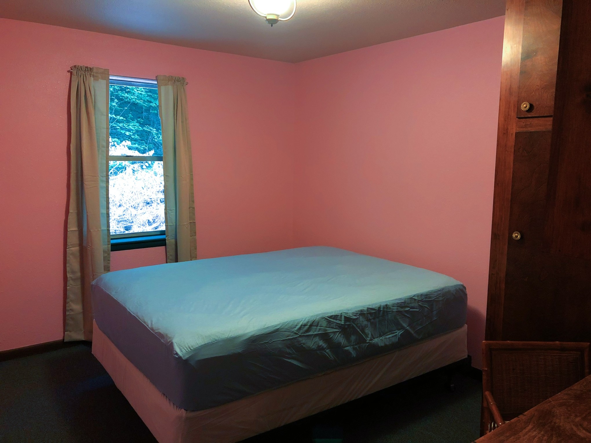 a bedroom with a bed in a room