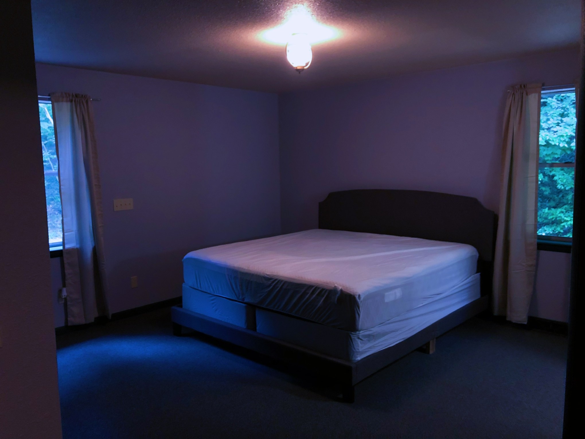 a bedroom with a bed and desk in a room