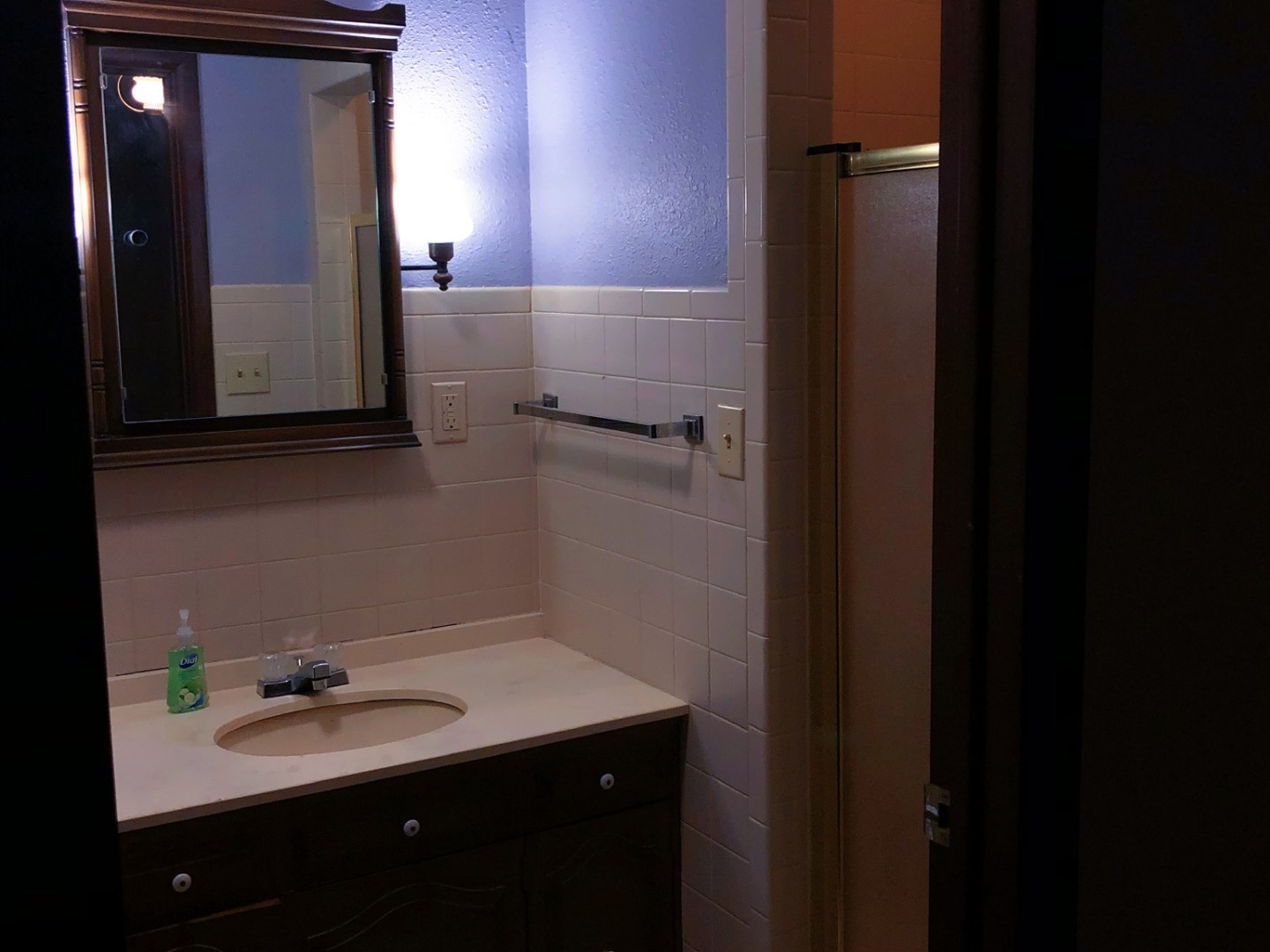 a kitchen with a sink and a mirror