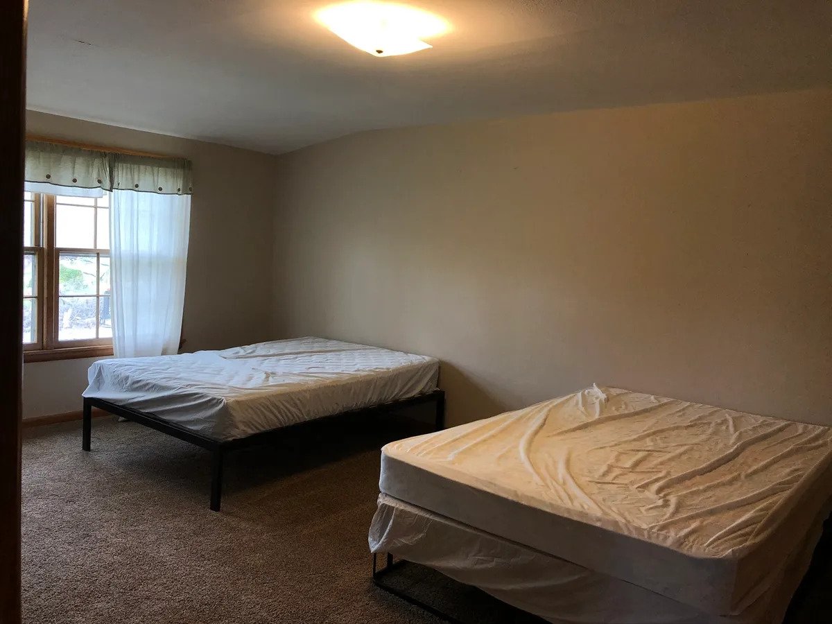 a bedroom with a bed in a room