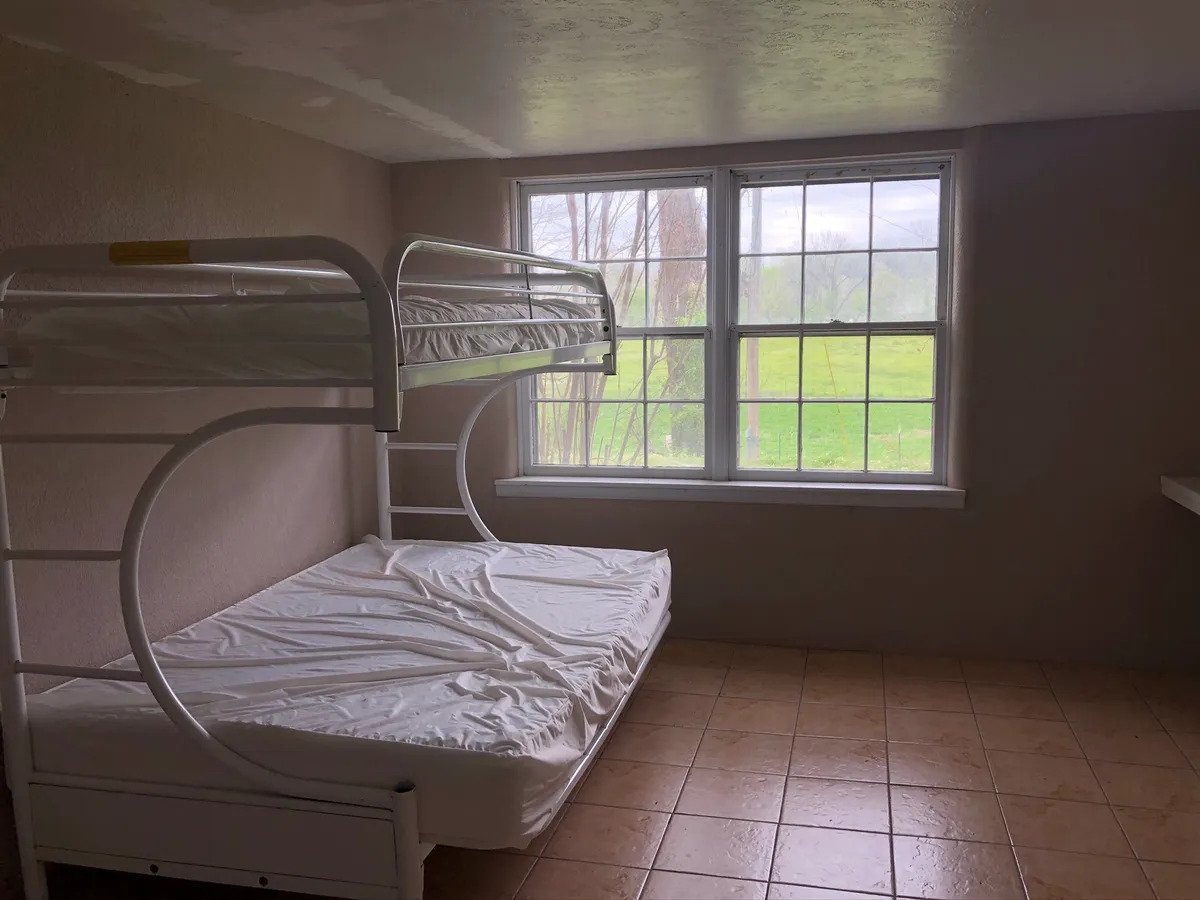 a bedroom with a bed and a window