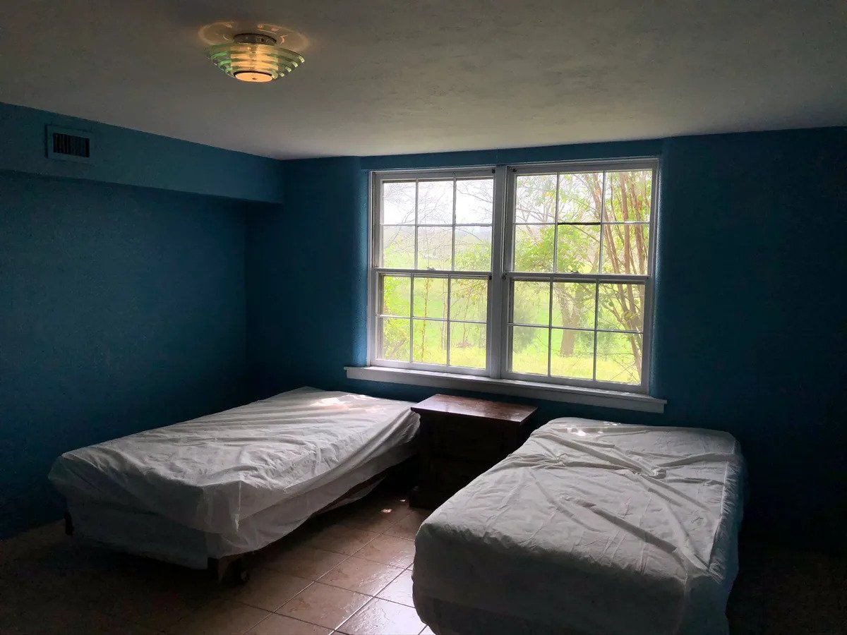 a bedroom with a bed and a window