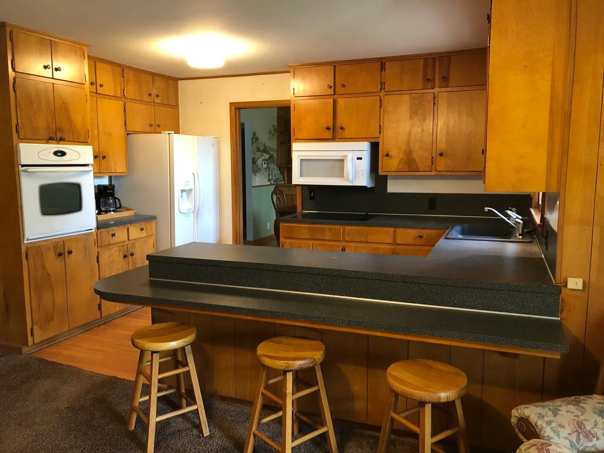a stove top oven sitting inside of a kitchen