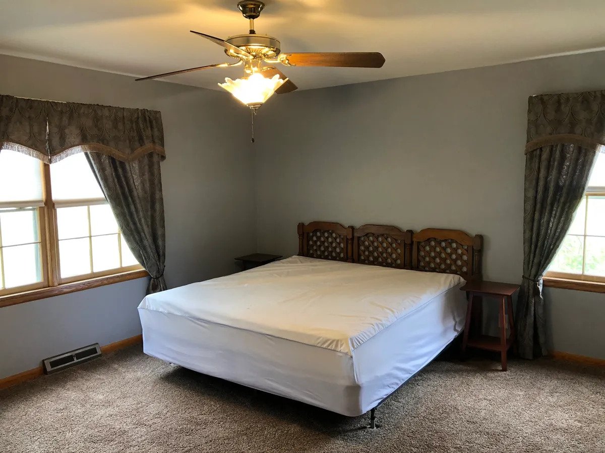 a bedroom with a bed in a room