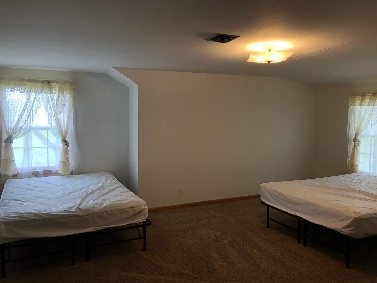 a bedroom with a large bed in a room