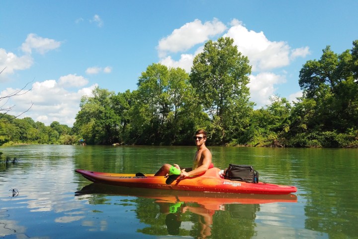 a person riding on the back of a boat in the water