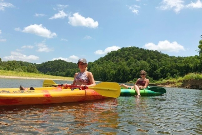 a group of people in a small boat in a body of water